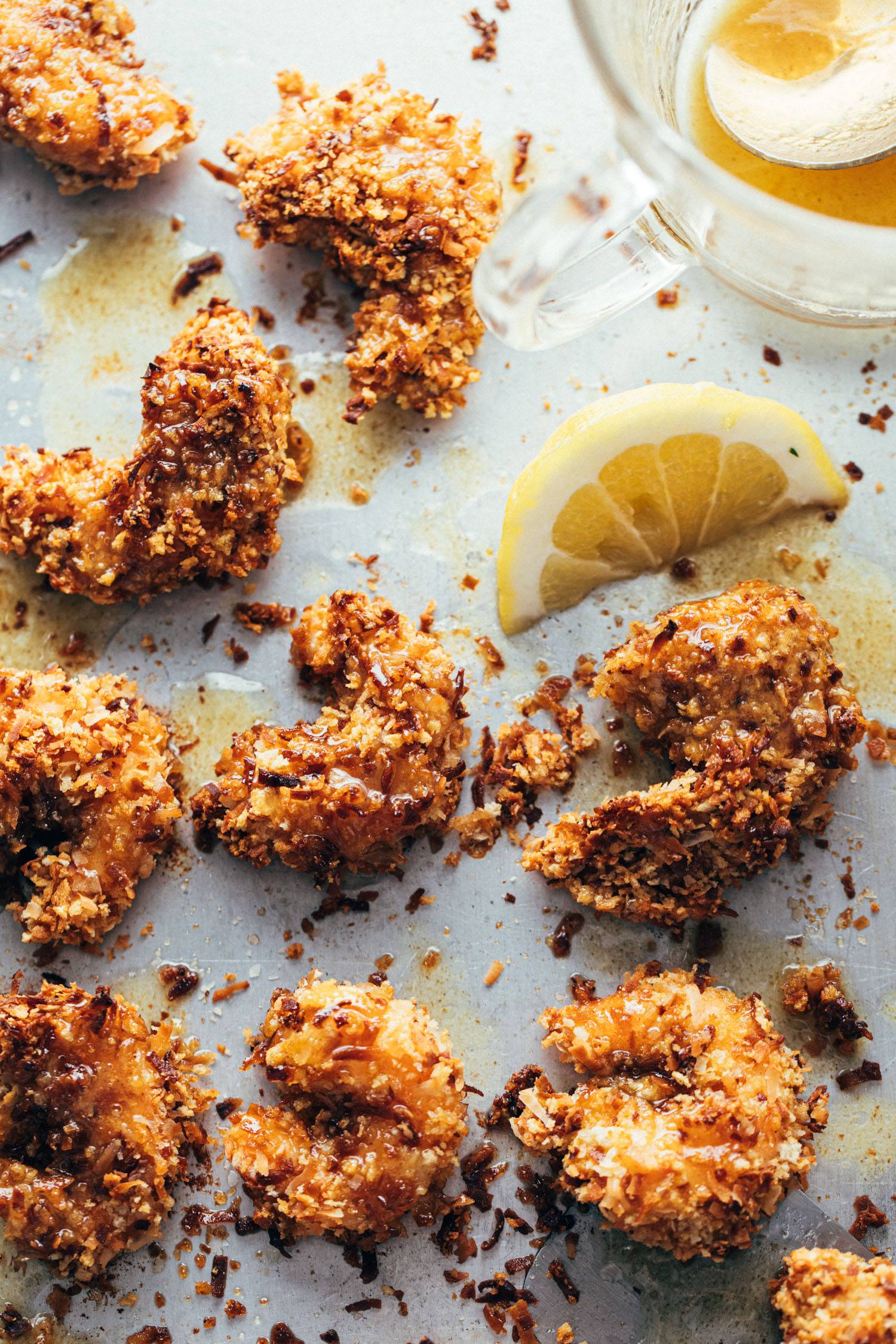 Baked coconut shrimp on a sheet pan with lemon and honey