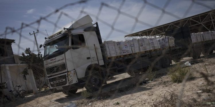 Humanitarian aid begins crossing into Gaza Strip